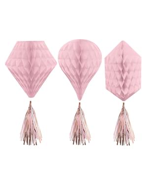 Pink honeycomb paper hanging decoration and pom poms in various shapes