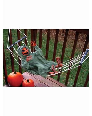 Hanging pumpkin figure in a hammock