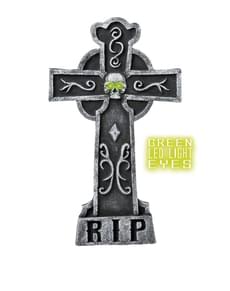 Gravestone with skull luminous green eyes