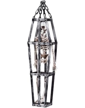 Figurină cu pandantiv cu schelet în cușcă