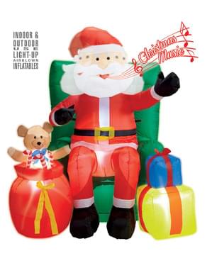 Figura decorativa de Pai Natal sentado sobre sofá gigante